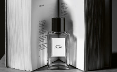 Bottle of Celine Rimbaud fragrance in front of an open book