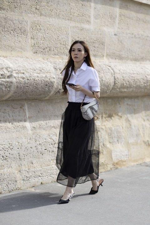 woman white shirt sheer black skirt